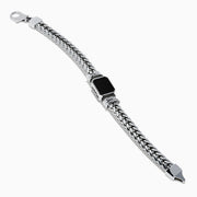 The Mens 925 Sterling Silver Onyx and Black Diamond Bracelet features a woven chain design, a rectangular onyx center stone in a decorative frame, black diamond accents, and a secure lobster clasp closure.