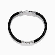 The Men's 925 Sterling Silver Black Spinel Leather Bracelet features black braided leather, sterling silver accents, and a decorative clasp with a black and silver loop design, displayed on a white background.