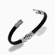 The Men's 925 Sterling Silver Black Spinel Leather Bracelet features black braided leather, sterling silver accents, and a decorative clasp with a black and silver loop design, displayed on a white background.