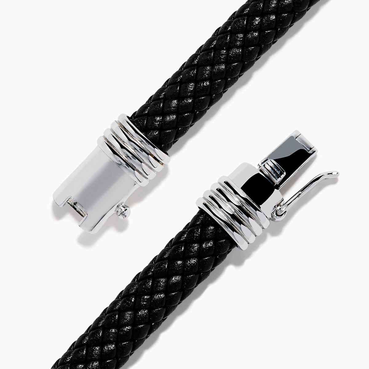 The Men's 925 Sterling Silver Black Spinel Leather Bracelet features black braided leather, sterling silver accents, and a decorative clasp with a black and silver loop design, displayed on a white background.