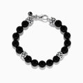 The Mens 925 Sterling Silver Onyx Bracelet features shiny black round beads, three ornate sterling silver spacers, a silver lobster clasp, and a small charm, displayed on a white background.