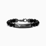 The Mens Sterling Silver Beaded Black Agate Bracelet features round black agate beads, sterling silver accents, a rectangular plate engraved with a starburst, and two cylindrical silver beads with star motifs near the clasp.