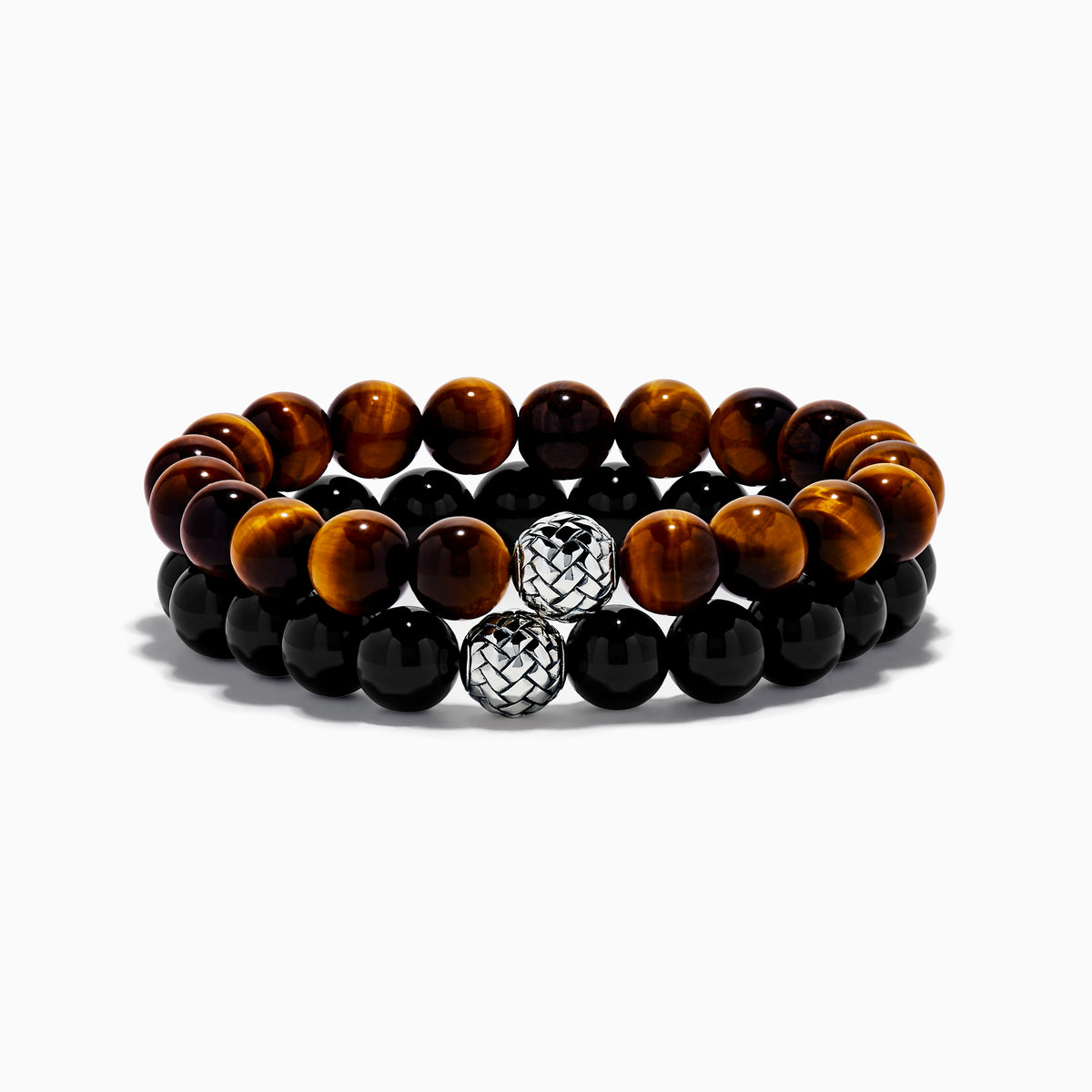 The Tiger's Eye and Onyx Beaded 2-Piece Bracelet Set with Sterling Silver features brown and black beads, each bracelet accented by a single sterling silver bead with a textured, woven pattern for an elegant stacked look.