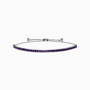 The 925 Sterling Silver Amethyst Bolo Bracelet showcases a single row of small, round amethyst gems set along the band, displayed on a plain white background.
