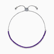 The 925 Sterling Silver Amethyst Bolo Bracelet showcases a single row of small, round amethyst gems set along the band, displayed on a plain white background.