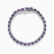 The 925 Sterling Silver Purple Amethyst Bracelet is shown on a plain white background, featuring faceted round amethyst gemstones in a classic tennis style.