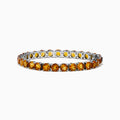 The 925 Sterling Silver Citrine Bracelet showcases a single row of round, faceted amber-orange citrine stones in prong settings against a white background.