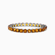 The 925 Sterling Silver Citrine Bracelet showcases a single row of round, faceted amber-orange citrine stones in prong settings against a white background.