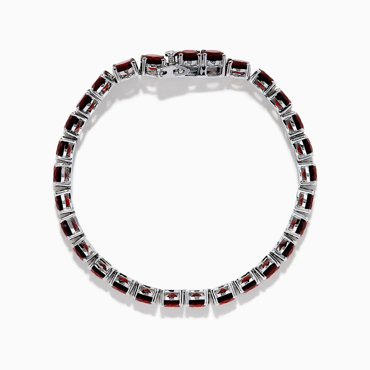 The 925 Sterling Silver Garnet Bracelet features round, deep red garnets set in individual prongs along a sleek tennis chain, beautifully arranged in a circular shape on a white background.