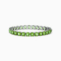 The 925 Sterling Silver Peridot Bracelet showcases a row of oval, bright green gemstones set against a white background for a striking look.