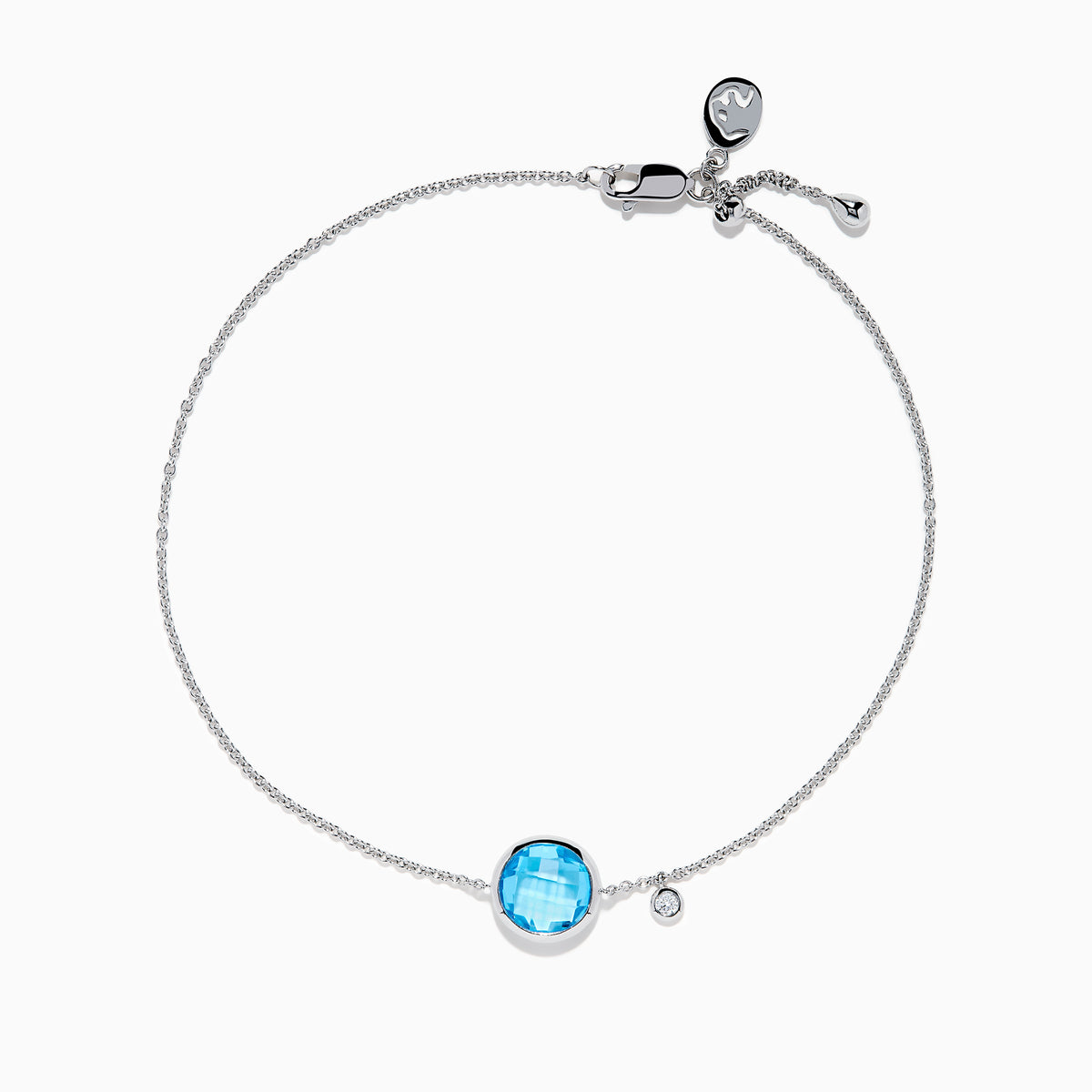 The Ocean Bleu 14K White Gold Blue Topaz and Diamond Bolo Bracelet features a delicate chain, a central round blue topaz, sparkling diamonds, and an adjustable clasp with a small charm near the closure.