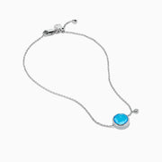 The Ocean Bleu 14K White Gold Blue Topaz and Diamond Bolo Bracelet features a delicate chain, a central round blue topaz, sparkling diamonds, and an adjustable clasp with a small charm near the closure.