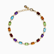 The Mosaic 14K Yellow Gold Bezel Multi Color Gemstone Bracelet showcases blue, green, purple, red, and amber rectangular stones evenly spaced along a delicate chain with an adjustable clasp.