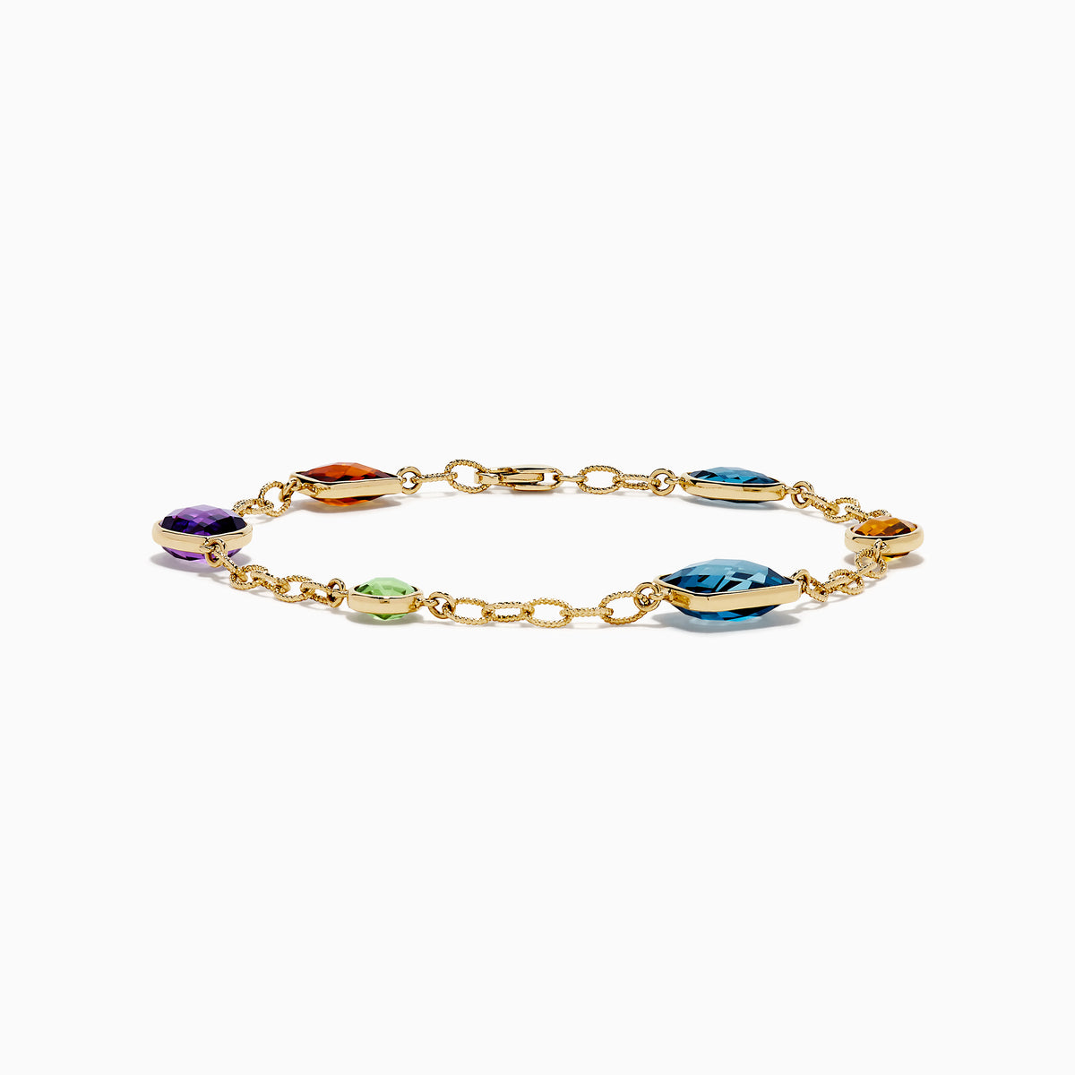 The Mosaic 14K Yellow Gold Multi Gemstone Station Bracelet features five colorful gemstones—blue, green, orange, red, and purple—in various shapes along a gold chain. Shown on a white background, it’s a vibrant accessory for any occasion.