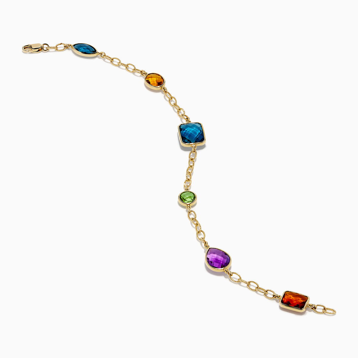 The Mosaic 14K Yellow Gold Multi Gemstone Station Bracelet features five colorful gemstones—blue, green, orange, red, and purple—in various shapes along a gold chain. Shown on a white background, it’s a vibrant accessory for any occasion.