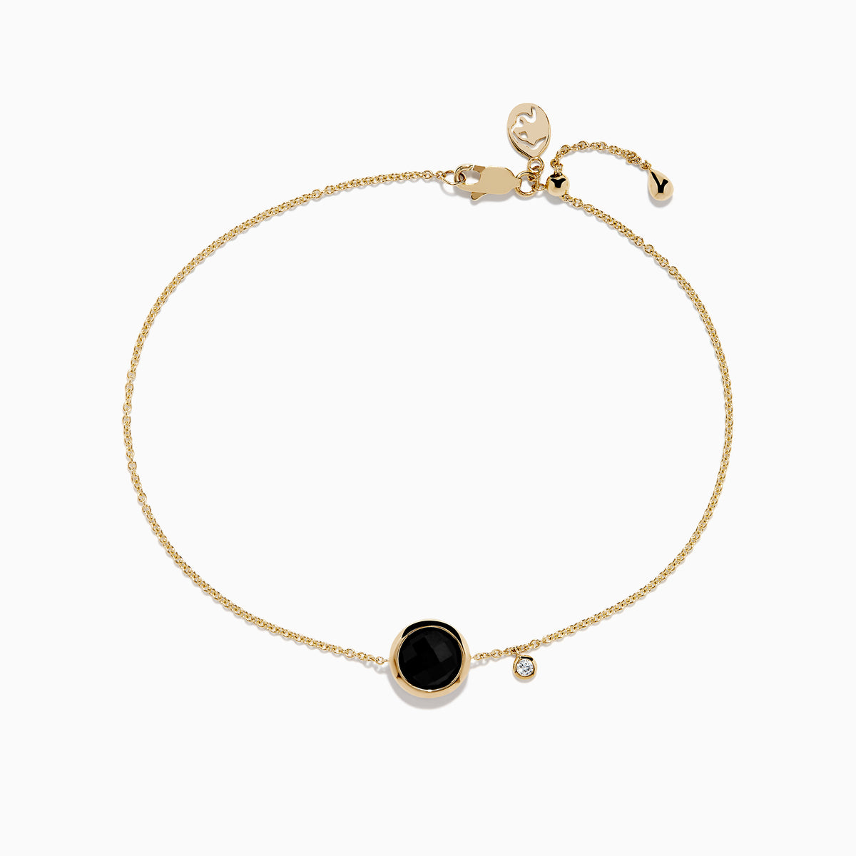The 14K Yellow Gold Onyx and Diamond Bolo Bracelet features a delicate gold chain with a round onyx in a bezel setting, an accent diamond charm, and is finished with a bolo clasp and heart-shaped tag.