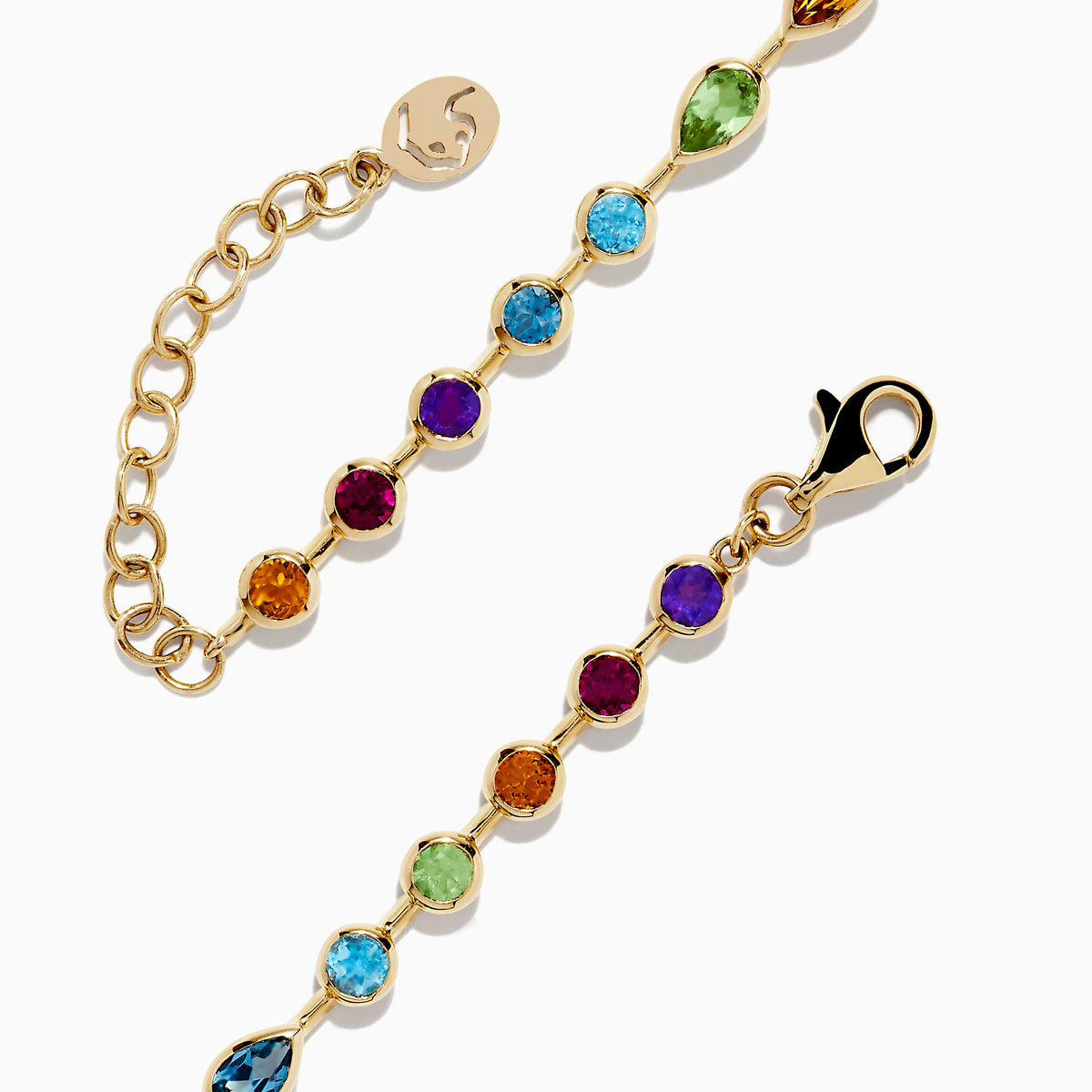 The Mosaic 14K Yellow Gold Bezel Set Multi Gemstone Adjustable Tennis Bracelet (7.0 TCW) features faceted oval gemstones in purple, blue, green, and orange hues with an adjustable clasp, shown on a white background.