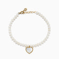 The 14K Gold Fresh Water Pearl and Mother of Pearl Heart Charm Bracelet features a gold clasp and extender, with a heart charm outlined in gold and filled with iridescent mother of pearl, shown against a white background.