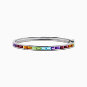 The 925 Sterling Silver Baguette Multi Color Gemstone Bangle showcases a row of vibrant rainbow-hued gemstones set along the front.