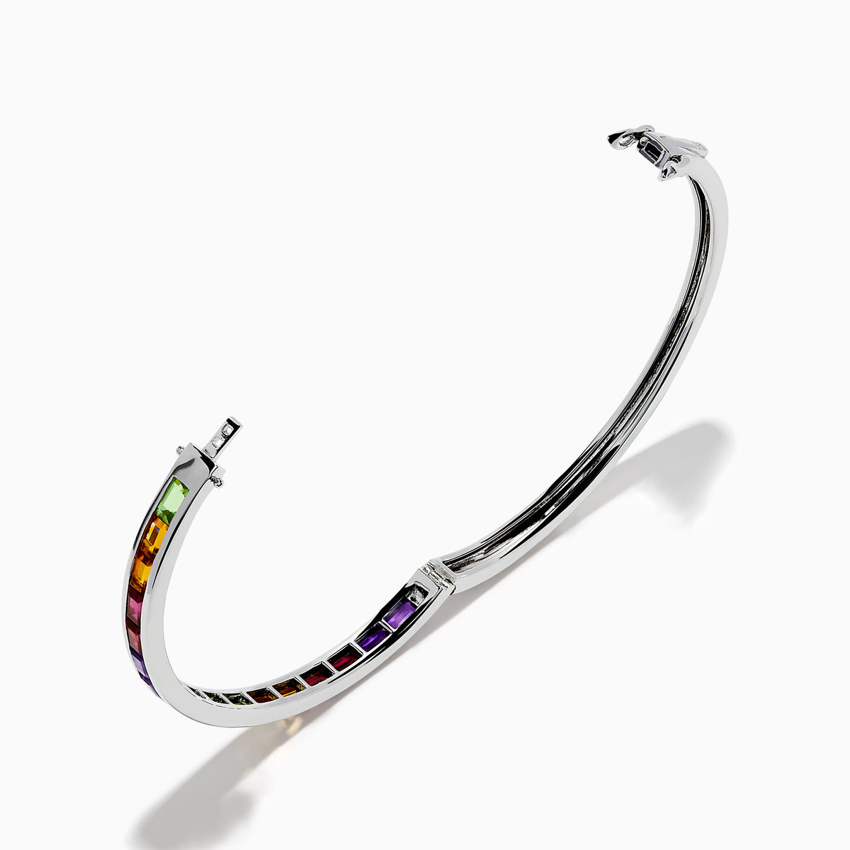 The 925 Sterling Silver Baguette Multi Color Gemstone Bangle showcases a row of vibrant rainbow-hued gemstones set along the front.