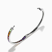 The 925 Sterling Silver Baguette Multi Color Gemstone Bangle showcases a row of vibrant rainbow-hued gemstones set along the front.