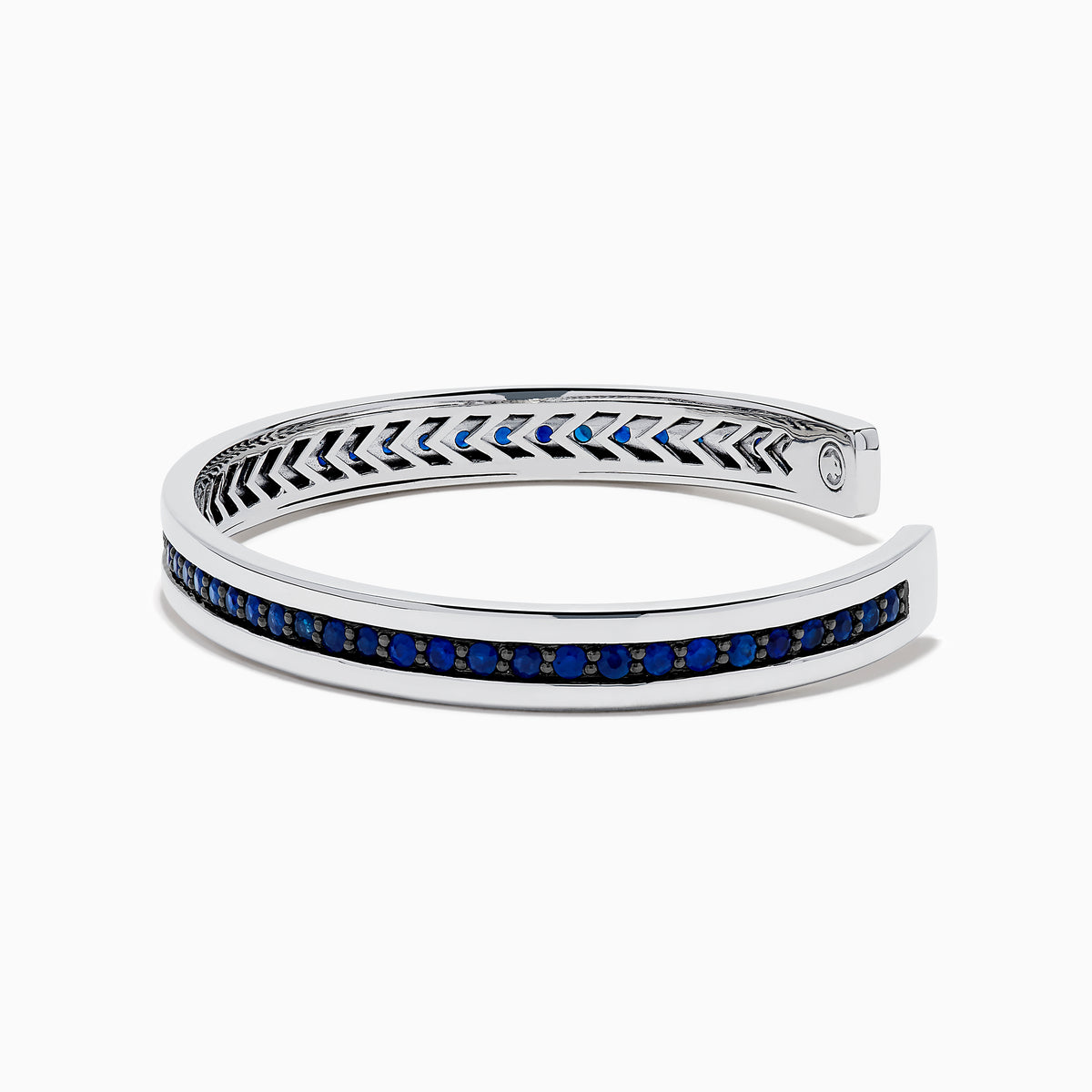 The Men's 925 Sterling Silver and Blue Sapphire Bracelet features a row of blue sapphires at the center and black chevron accents on the edges, offering a bold update to the classic blue sapphire bracelet.