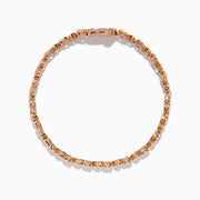 A Rose Plated Sterling Silver Diamond Hearts Tennis Bracelet, featuring alternating heart-shaped links with sparkling diamonds, is displayed against a white background.