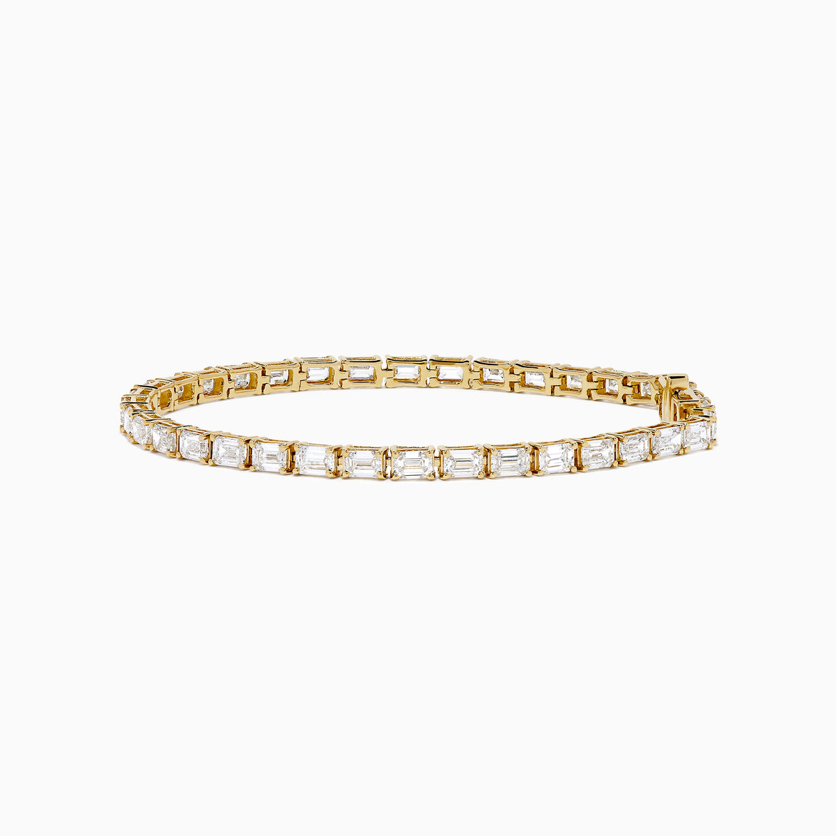 The Lab Grown Emerald Cut Diamond 7.50ct Tennis Bracelet in 14K Yellow Gold features a single row of rectangular lab-grown diamonds, elegantly set and displayed on a plain white background.