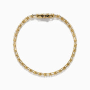 The Lab Grown Emerald Cut Diamond 7.50ct Tennis Bracelet in 14K Yellow Gold features a single row of rectangular lab-grown diamonds, elegantly set and displayed on a plain white background.