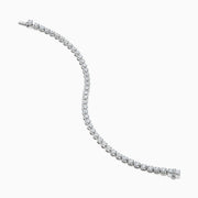 The Lab Grown Round Diamond 5.00ct Cupcake Setting Tennis Bracelet in 14K White Gold features a slender band adorned with a continuous row of sparkling lab grown diamonds.
