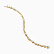 The Lab Grown Round Diamond 5.00ct Cupcake Setting Tennis Bracelet in 14K Yellow Gold features a single row of prong-set lab grown diamonds, shown against a white background.
