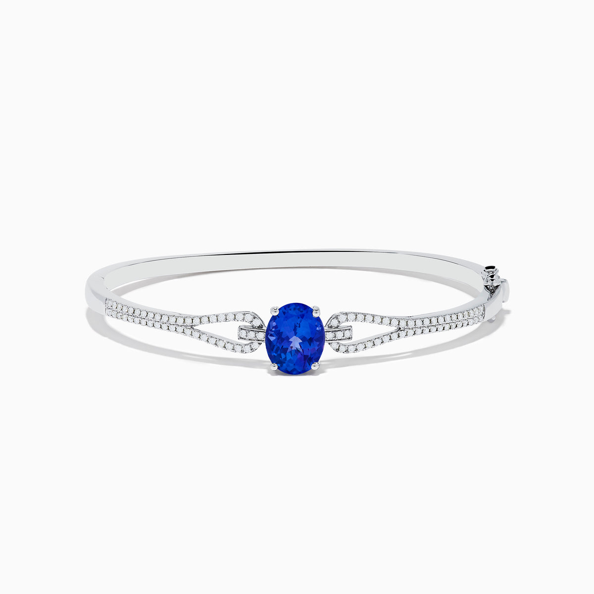 The 14K White Gold Tanzanite and Diamond Bangle showcases a striking round tanzanite centerpiece, accented by rows of sparkling diamonds along the band.