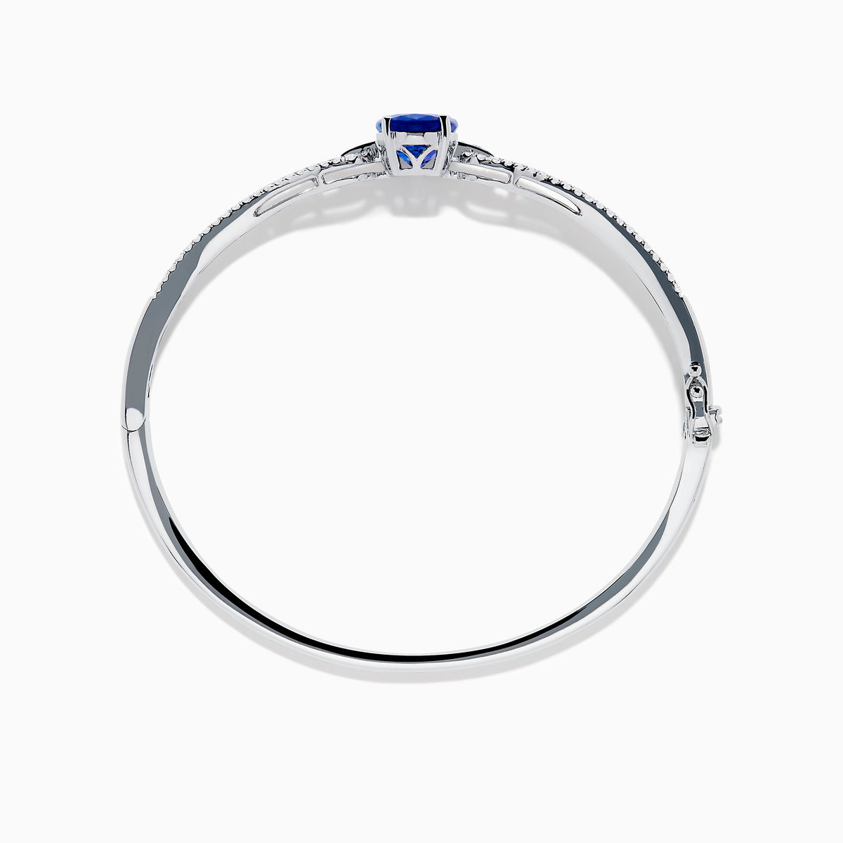 The 14K White Gold Tanzanite and Diamond Bangle showcases a striking round tanzanite centerpiece, accented by rows of sparkling diamonds along the band.