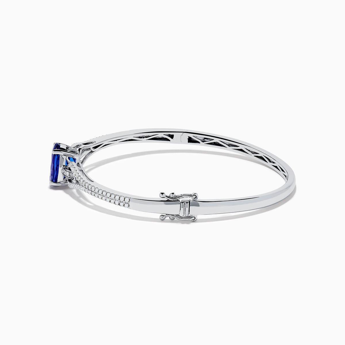 The 14K White Gold Tanzanite and Diamond Bangle showcases a striking round tanzanite centerpiece, accented by rows of sparkling diamonds along the band.