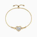 The 14K Yellow Gold Mother of Pearl Heart Bolo Bracelet features a central heart-shaped Mother of Pearl framed by gold beads, with an adjustable slider clasp on a delicate gold chain.
