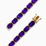The 14K Yellow Gold Radiant Cut Amethyst Tennis Bracelet showcases a row of radiant cut amethysts in prong settings, displayed against a white background.