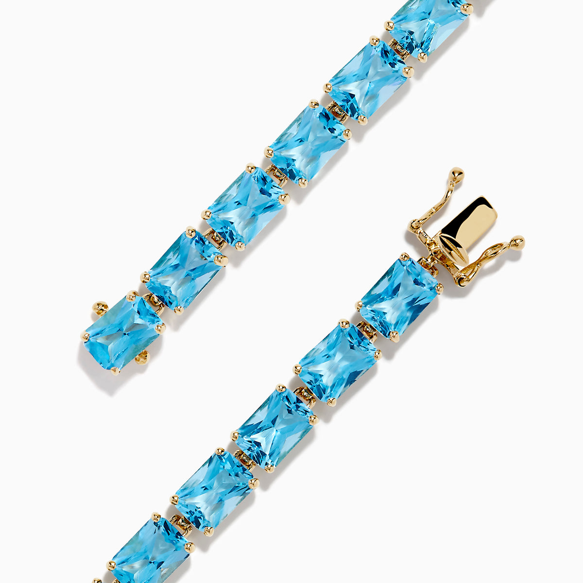 The Ocean Bleu 14K Yellow Gold Radiant Cut Blue Topaz Tennis Bracelet features rectangular blue topaz gemstones set in individual links, displayed on a plain white background.