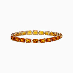 The Sunset 14K Yellow Gold Radiant Cut Citrine Tennis Bracelet showcases rectangular, faceted amber-hued gemstones in individual prong settings along a classic yellow gold chain.