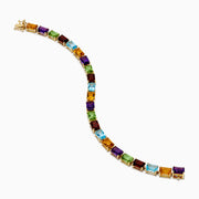 The 14K Yellow Gold Radiant Cut Multi Color Gemstone Tennis Bracelet showcases a continuous line of rectangular purple, red, blue, green, and yellow stones.