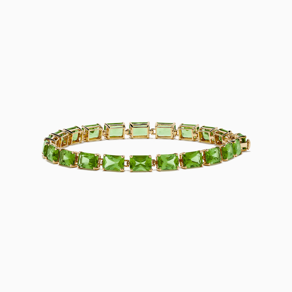 The 14K Yellow Gold Radiant Cut Peridot Tennis Bracelet features rectangular green peridot gemstones evenly spaced and connected, displayed on a white background.