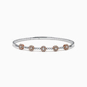 The 14K Two-Tone Gold Pink and White Diamond Flexible Bangle features round pink and white diamond clusters linked on a slender, polished band—a modern, refined update on the classic diamond bangle.