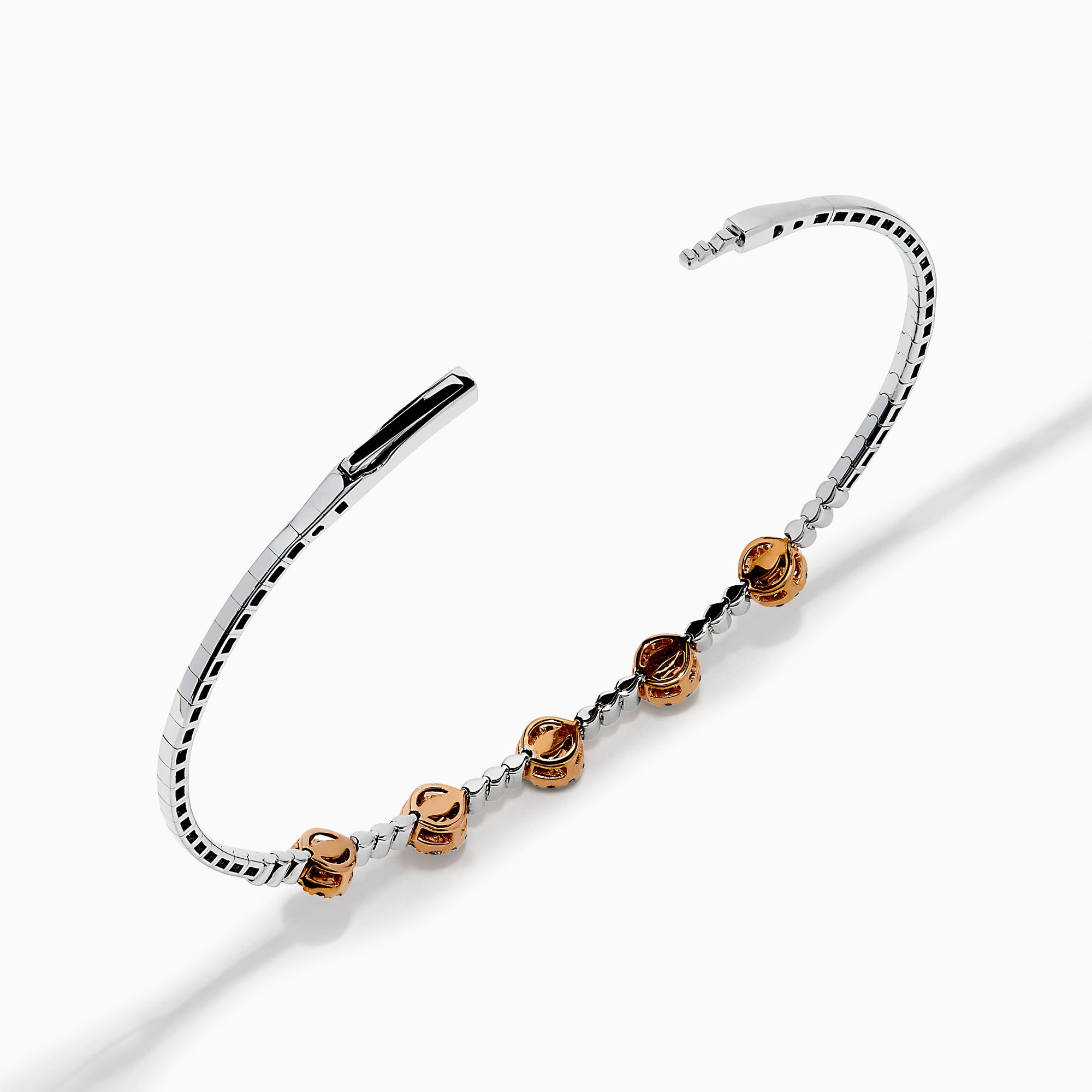 The 14K Two-Tone Gold Pink and White Diamond Flexible Bangle features round pink and white diamond clusters linked on a slender, polished band—a modern, refined update on the classic diamond bangle.