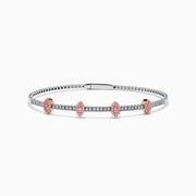 The 14K Two-Tone Gold Pink and White Diamond Bangle features a delicate band with pink and white diamonds, including five marquise-shaped pink diamond clusters set in rose gold.