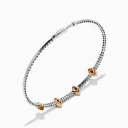 The 14K Two-Tone Gold Pink and White Diamond Bangle features a delicate band with pink and white diamonds, including five marquise-shaped pink diamond clusters set in rose gold.