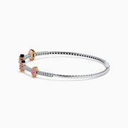 The 14K Two-Tone Gold Pink and White Diamond Bangle features a delicate band with pink and white diamonds, including five marquise-shaped pink diamond clusters set in rose gold.