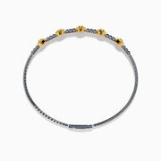 The Canare Platinum and 18K Yellow Gold Yellow and White Diamond Bangle features five oval yellow gold accents, each set with yellow diamonds, spaced along clear square-cut white diamonds for a sleek, elegant look.