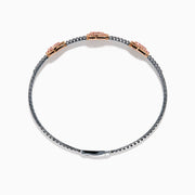 This Platinum and 14K Rose Gold Pink and White Diamond Bangle features three teardrop-shaped pink gemstone clusters framed by diamonds, creating an elegant look with evenly spaced gems along its slender silver-toned band.