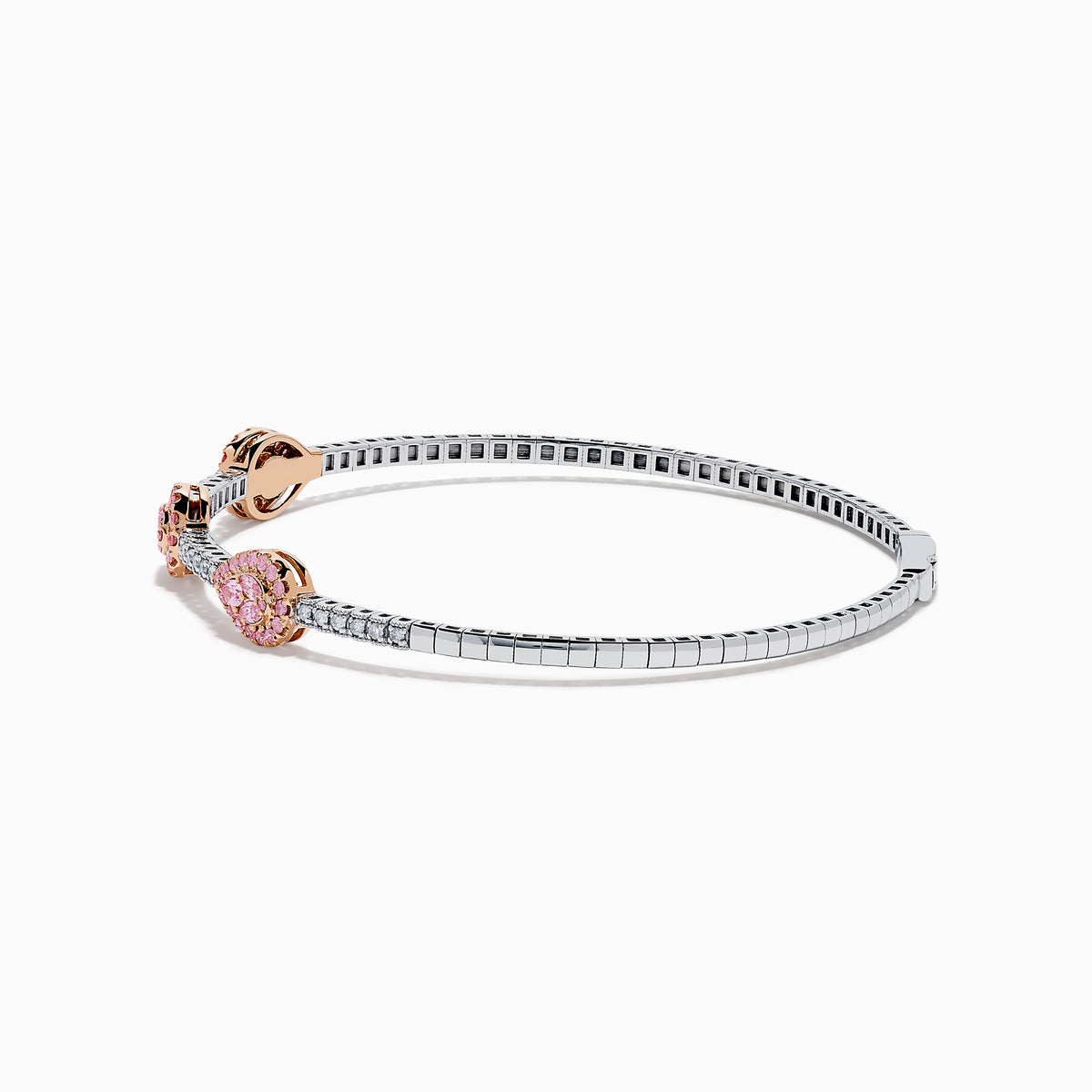 This Platinum and 14K Rose Gold Pink and White Diamond Bangle features three teardrop-shaped pink gemstone clusters framed by diamonds, creating an elegant look with evenly spaced gems along its slender silver-toned band.