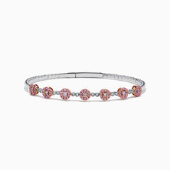 The 14K White and Rose Gold Light Pink and White Diamond Bangle features a sleek silver band with seven clusters of light pink diamonds, each separated by a small white gemstone.