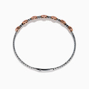 The 14K White and Rose Gold Light Pink and White Diamond Bangle features a sleek silver band with seven clusters of light pink diamonds, each separated by a small white gemstone.